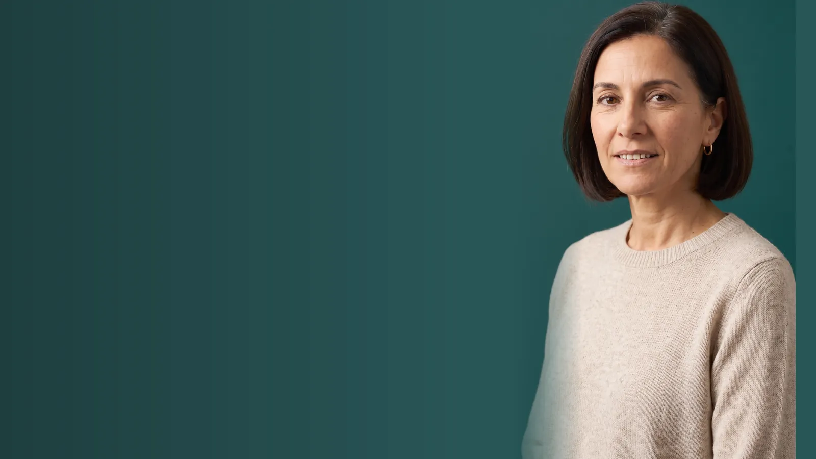 Lisa Marchetti, the instructor of The Ozempic Face Fix, in a cream sweater against a dark green wall