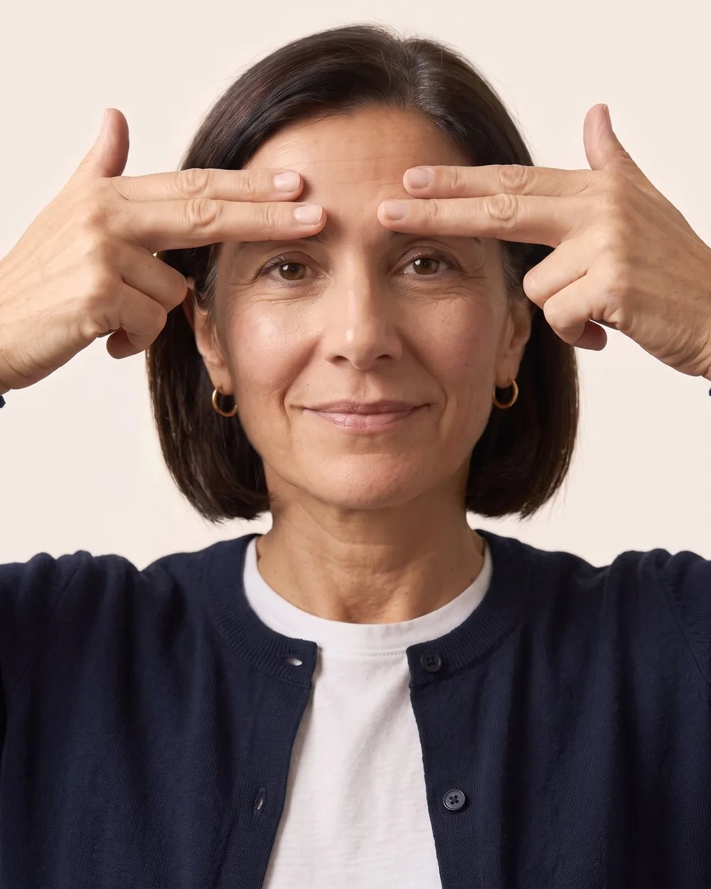 Fingertips laid flat across the forehead to keep it still during an exercise, as the wrinkle rule teaches